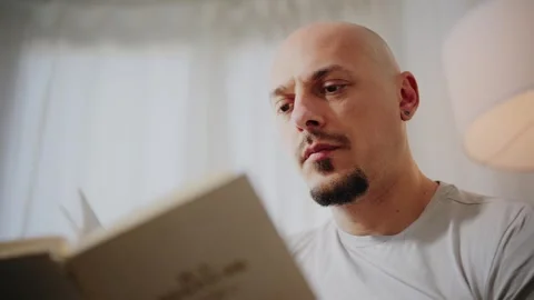 Man Reading a Book at Home Stock Footage 297991443