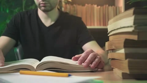 A man is reading a book in the library Stock Footage 264094840