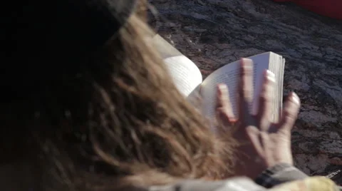 Man reading book outside 動画素材 50957971