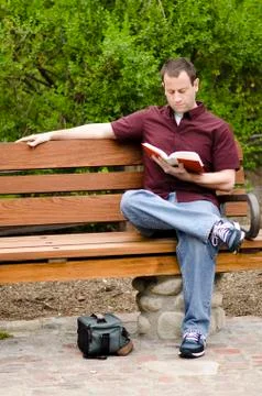 Man reading a book outside. Stock Photos