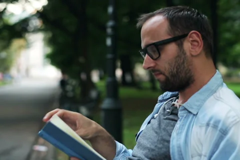 Man reading a book in the park Stock-Footage 33720116