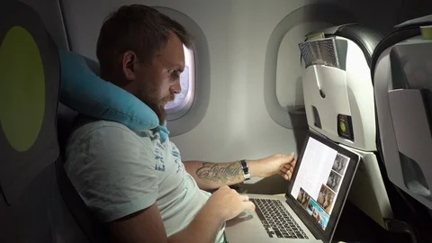 Man reading a book on a plane Stock Footage 101690294