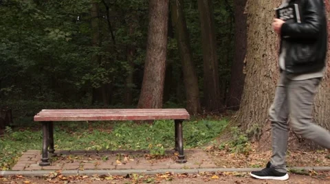 Man reading a book sitting on the bench Video stock 68910317