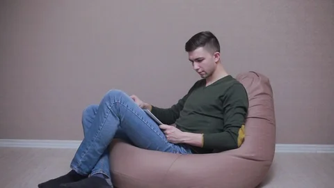 Man reading book on the sofa Stock Footage 88107206