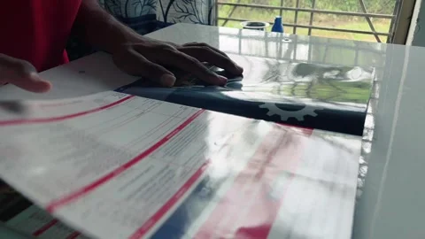 Man reading a book on table with sunlight coming through window in front Stock Footage 315019053