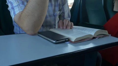 Man Reading Book in Train Stock Footage 92780659