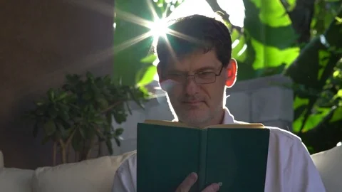 Man Reading Book Turns Page 動画素材 78477795