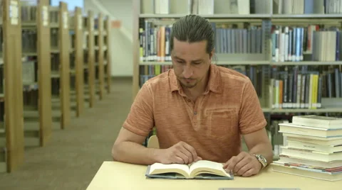 Man reading books in library Video stock 67364937