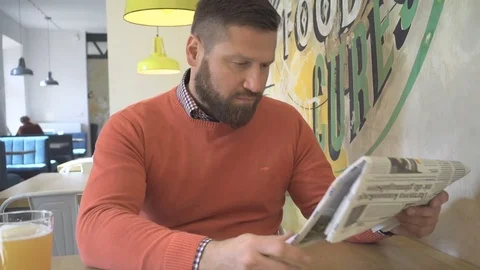 Man reading, browsing, daily newspaper, lunchtime, in cafe, indoor, steadicam 動画素材 73227965