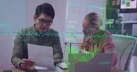 Man reading charts at table driving finance data and graphs while woman scanning Stock Footage 326994091