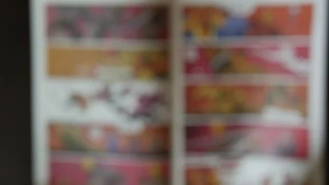 Man reading comic book out of focus - defocused concept video Stock Footage 92525921