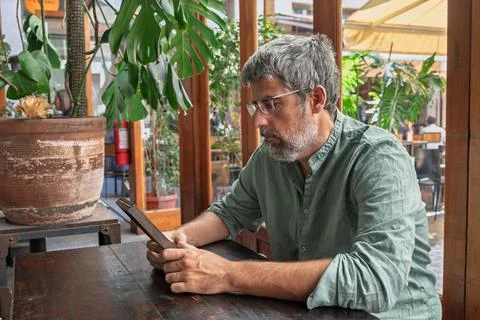 Man reading digital tablet in a casual cafe Stock Photos