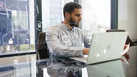Man reading doc typing laptop on glass table HUD moving glancing up confirming Stock Footage 334729033