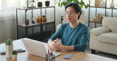 Man reading document while doing video conference on laptop Stock Footage 145296077