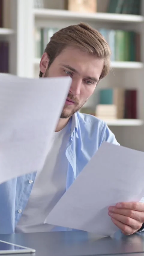 Man Reading Documents in Office, Vertical Video Stock Footage 339578738