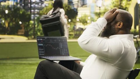 Man reading financial data graphs on forex web platform Stock Photos