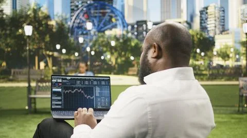 Man reading financial data graphs on forex web platform Stock Photos