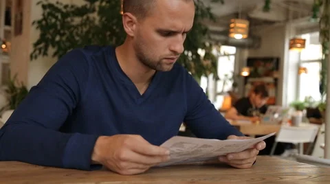 Man reading food menu sitting in cafe Stock Footage