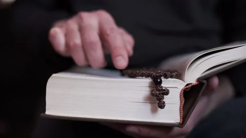 A man is reading the Holy Bible. The concept of prayer, religion, faith Stock Footage 221507438