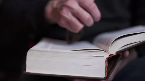 A man is reading the Holy Bible. The concept of prayer, religion, faith Stock Footage 273483025