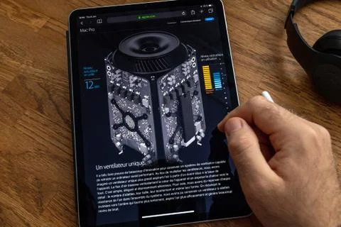 Man reading iPad Pro about mac Pro trash can workstation Stock Photos