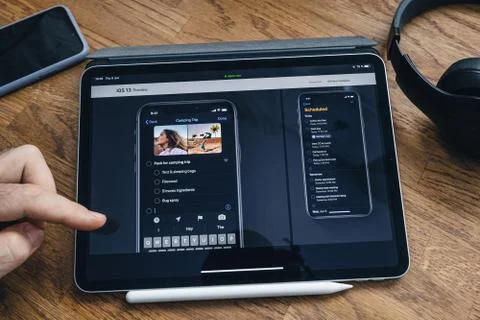 Man reading on iPad Pro about new iOS 13 Stock Photos