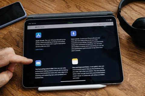 Man reading on iPad Pro about new iOS 13 Stock Photos