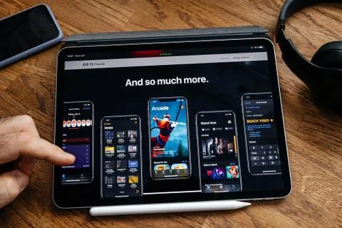 Man reading on iPad Pro about new iOS 13 Stock Photos