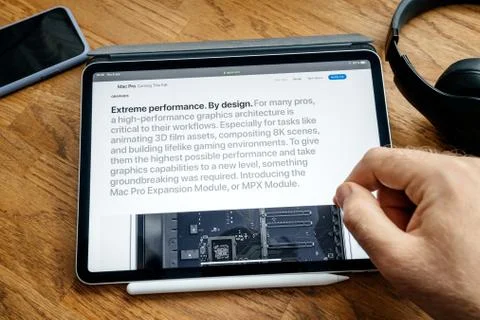 Man reading on iPad Pro launch Mac Pro workstation Stock Photos