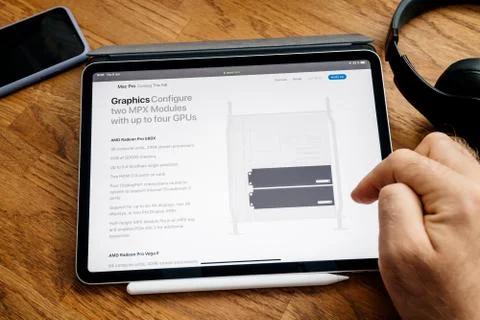 Man reading on iPad Pro launch Mac Pro workstation GPu modules Stock Photos