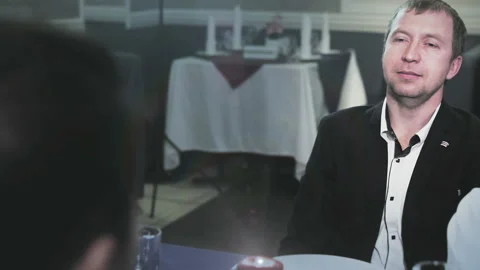 Man reading a label of champagne which is shown to him by a waiter Stock Footage 97577238