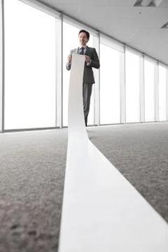 Man reading a long paper Stock Photos