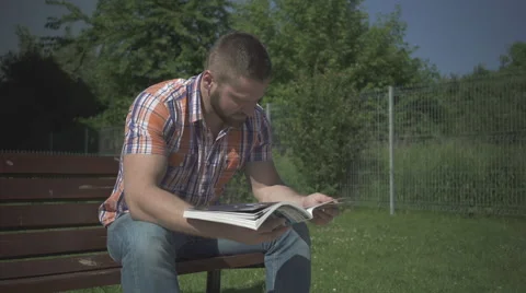 Man is reading magazine. Video stock 52688707