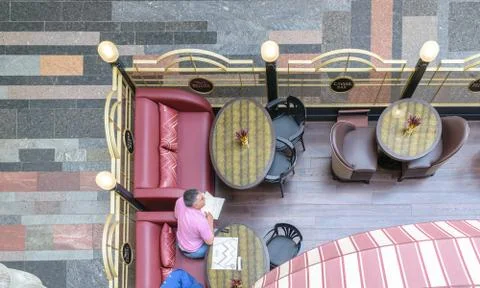 Man reading a menu of cafe "Caviar Bar" in GUM on Red Square Stock Photos