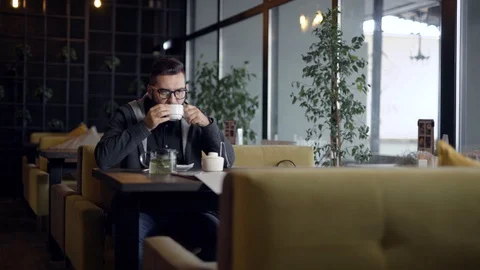Man reading menu at table in cafe Stock Footage 99039343