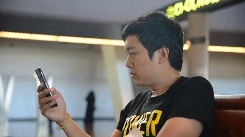 A man reading message on phone Stock Footage 69950654