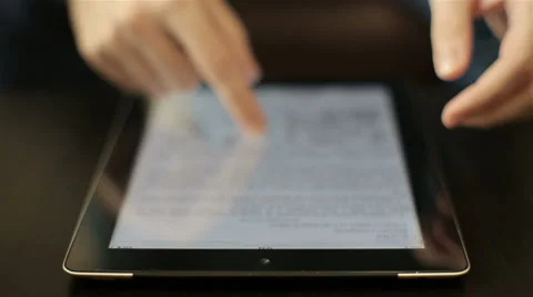 Man reading news on tablet computer.closeup finger touching tablet computer Stock Footage 61751009