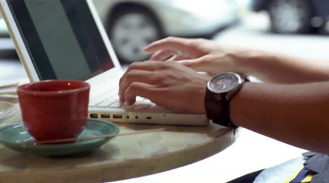 Man reading newspaper and drinking coffee in cafe while using laptop Stock-Footage 46159450