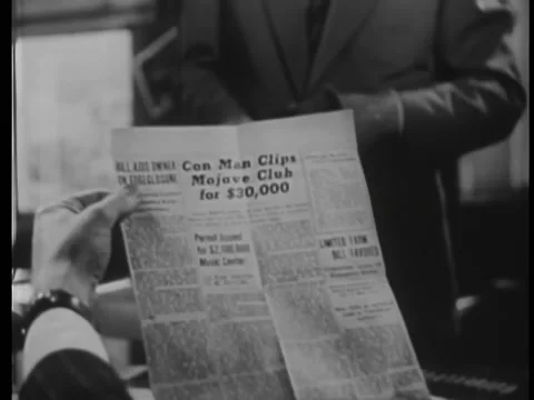 Man reading newspaper clipping Stock Footage 260256344
