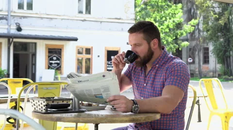 Man reading newspaper during breakfast Vídeo Stock 67628770