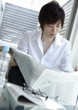Man reading a newspaper Stock Photos