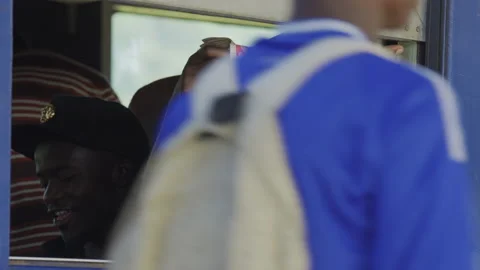 Man reading the newspaper by the train window In A Station.DaresSalaam Tanzania Stock Footage 131830814
