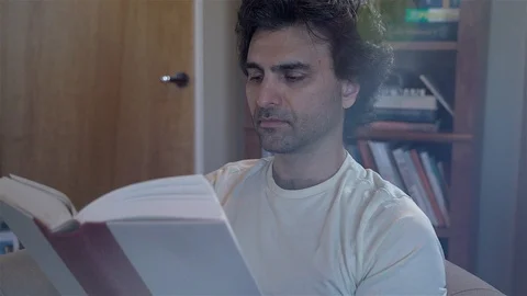 Man Reading Novel Stock Footage 99483111