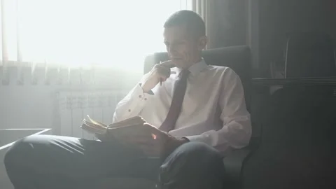 A man is reading an old book. Rays of light. 動画素材 209495070