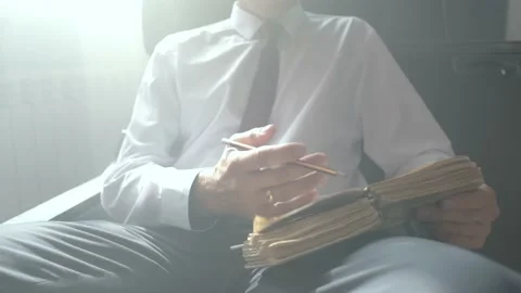 A man is reading an old book. Rays of light. Front view. Stock Footage 209495267