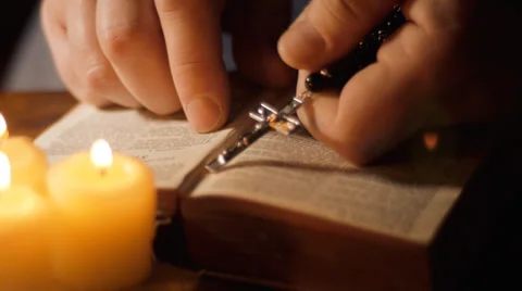 Man reading with rosary over open bible Stock Footage 36198030