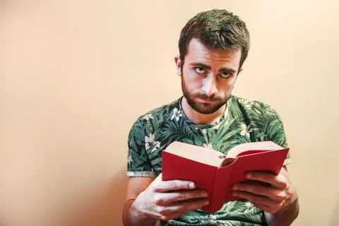 Man reading a sad book Stock Photos
