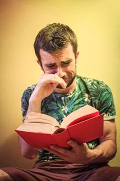 Man reading a sad book Stock Photos