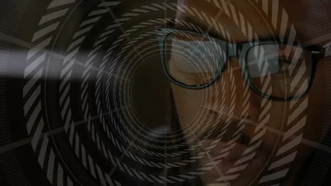 Man reading from screen, causing spiral overlay interacting with glasses glare Stock Footage 331735883