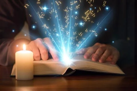Man reading shining book Stock Photos